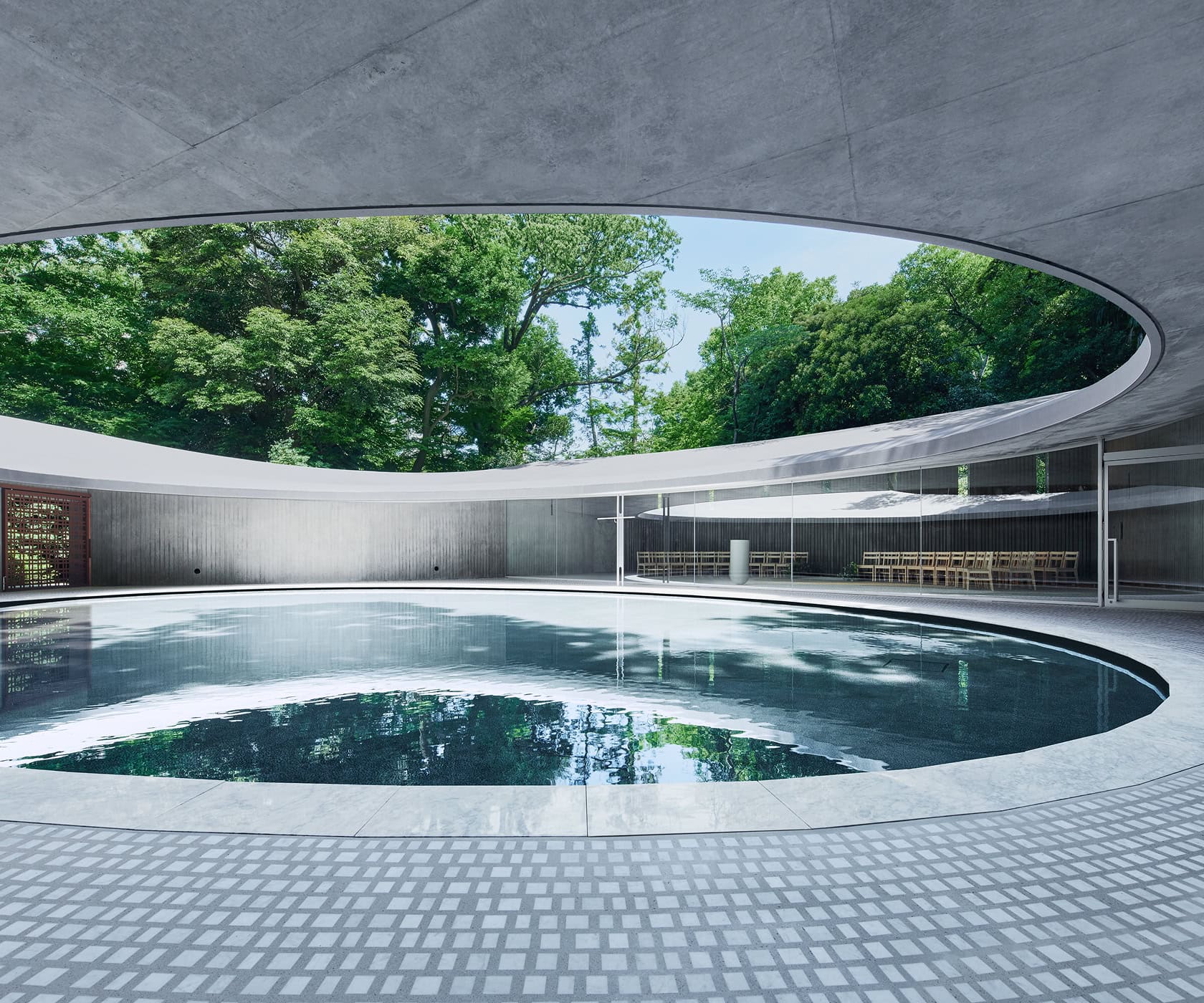 A sophisticated space set against the backdrop of a modern wedding venue, featuring an outdoor swimming pool and lush natural scenery.